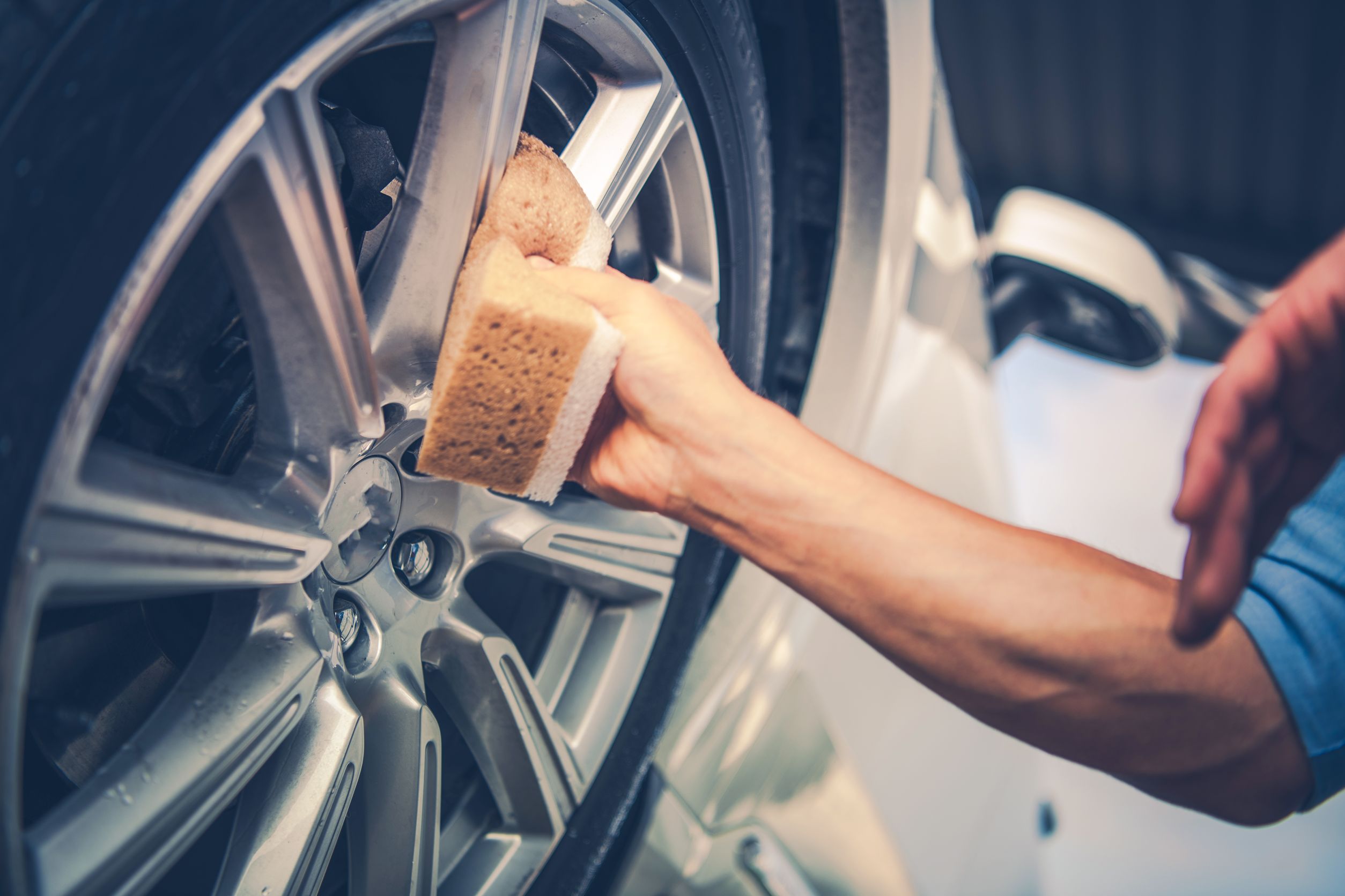 Men Cleaning Car Alloy Wheel